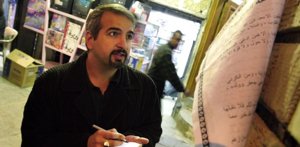Anthony Shadid takes notes outside Ayatollah Sistani's office in Najaf Dec. 3, 2003. The city of Najef, south of Baghdad, is the site of one of the holiest mosques' in Shiite religious beliefs. Shadid, a two-time Pulitzer Prize winner who strove to capture untold stories in Middle East conflicts from Libya to Iraq, died Thursday Feb. 16, 2012 in eastern Syria after slipping into the country to report on the uprising against its president. (AP Photo/Bill O'Leary, The Washington Post)